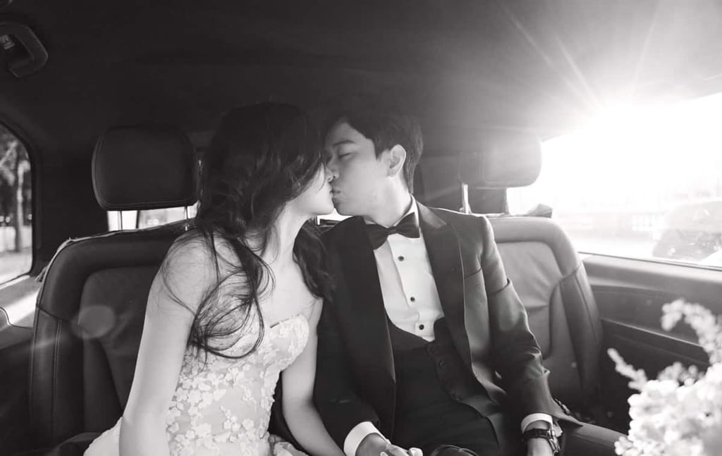 Bride and groom kissing in a car in Paris